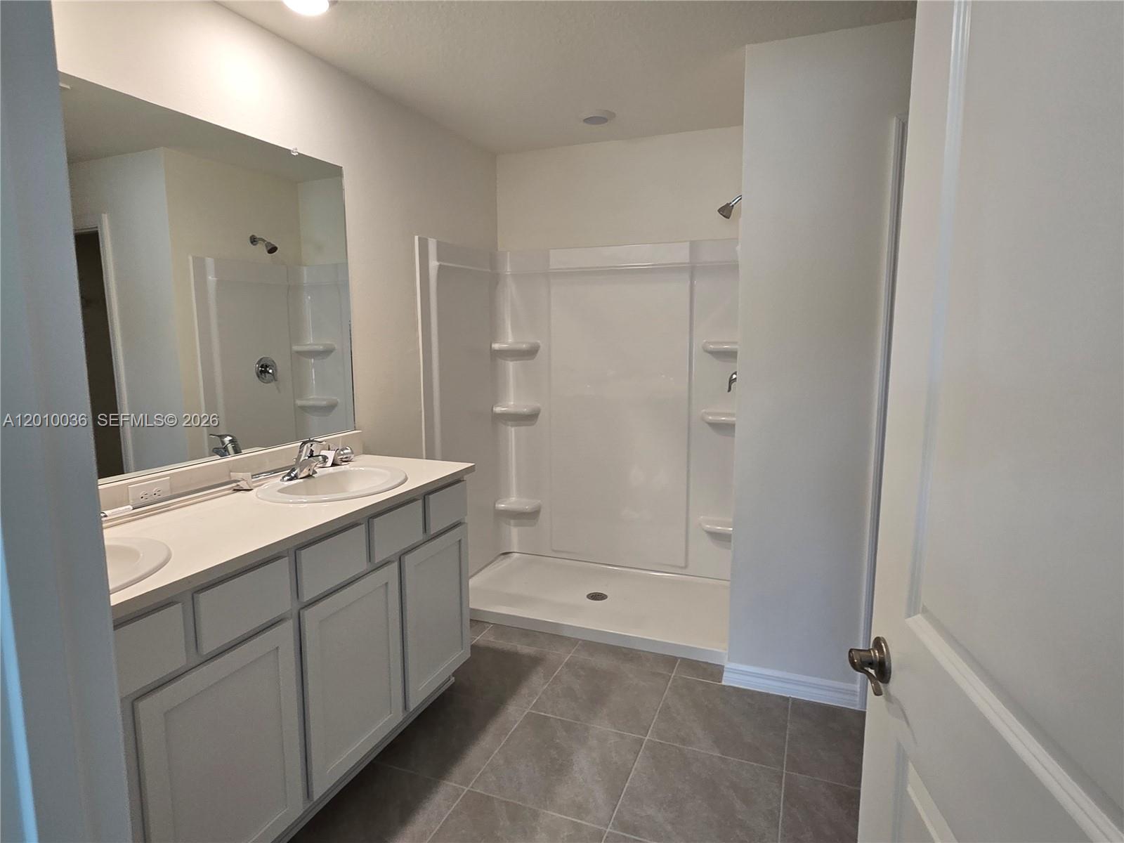 9871 Southeast 161st Lane Road Summerfield, FL 34491 - Photo 17 of 31 a bathroom with a sink double vanity and a mirror