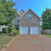 a front view of a house with a yard and a garage