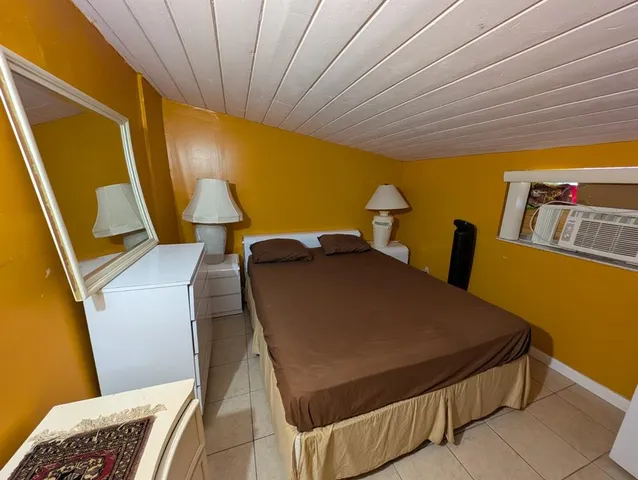 a bed sitting in a bedroom next to a blue wall