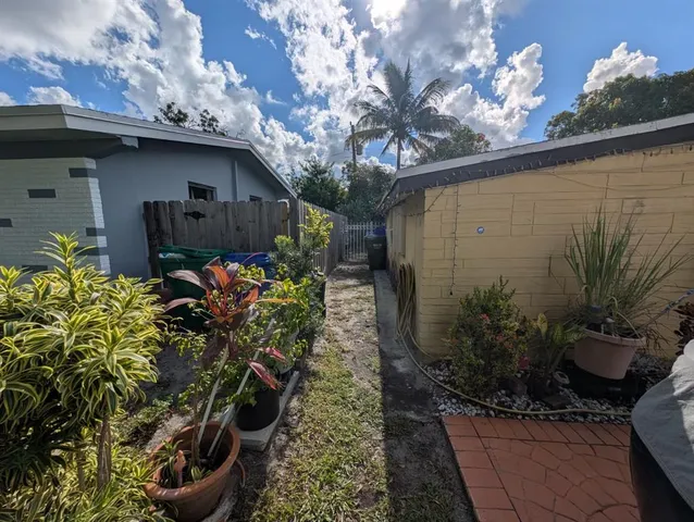 a vase of flowers sitting on a table in front of a house