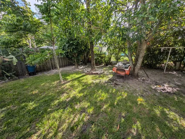 a view of a backyard with table and chairs
