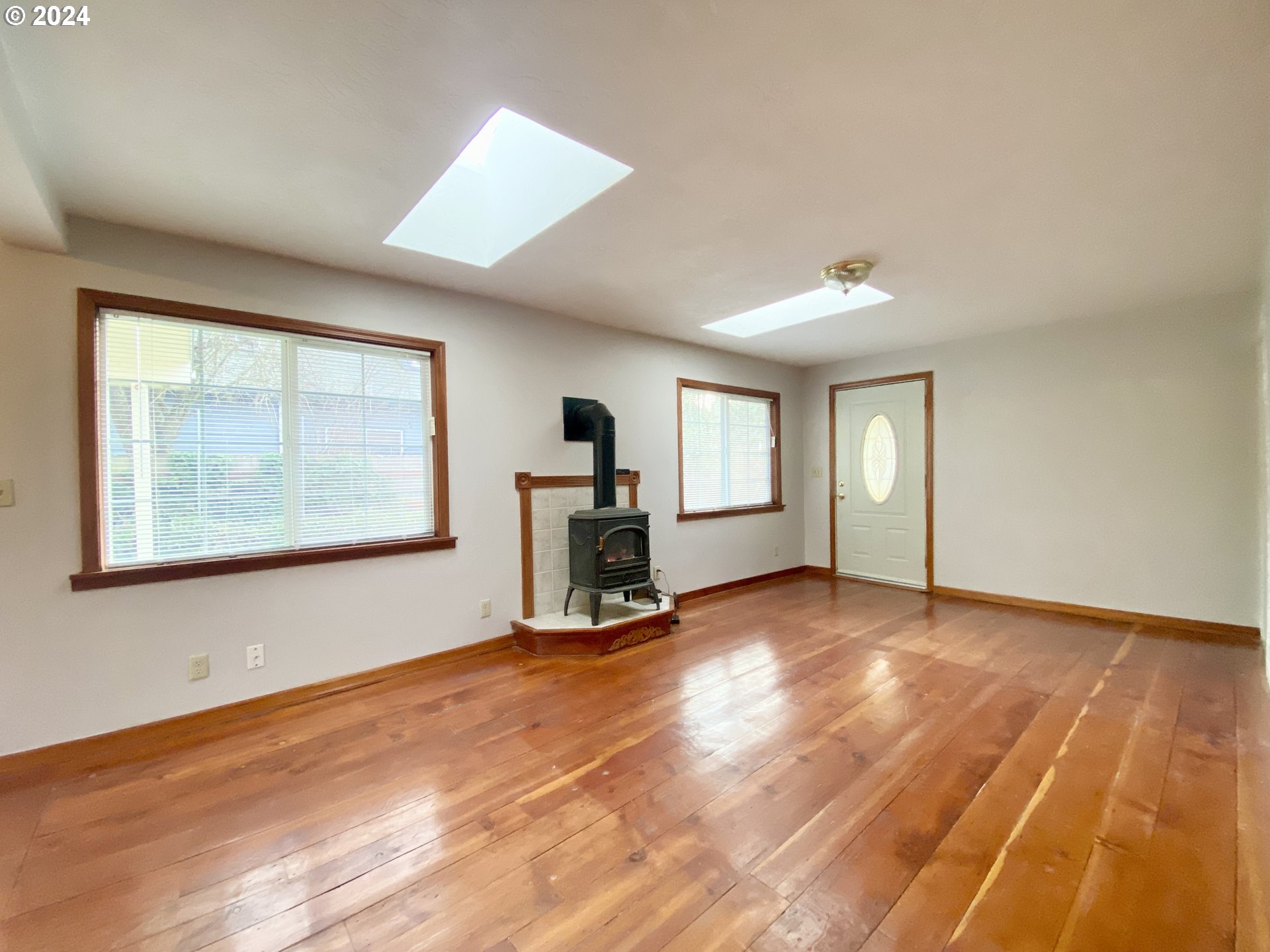 1027 Mill Street Springfield, OR 97477 - Photo 5 of 47 a view of an empty room with window and wooden floor