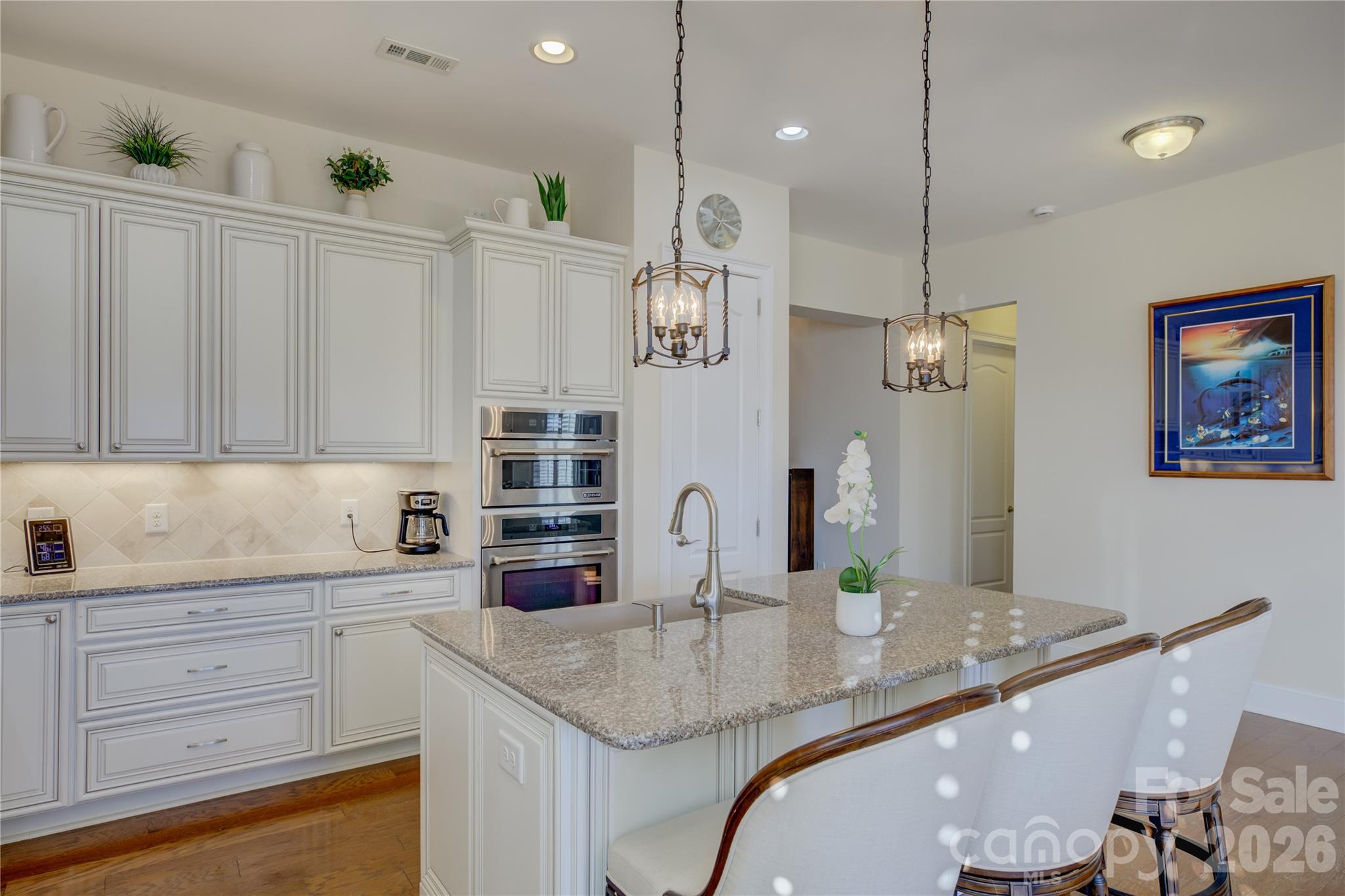 15511 Lake Ridge Road Charlotte, NC 28278 - Photo 12 of 46 a kitchen with stainless steel appliances granite countertop a sink a refrigerator and wooden cabinets