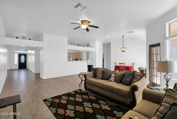 a living room with furniture and a chandelier