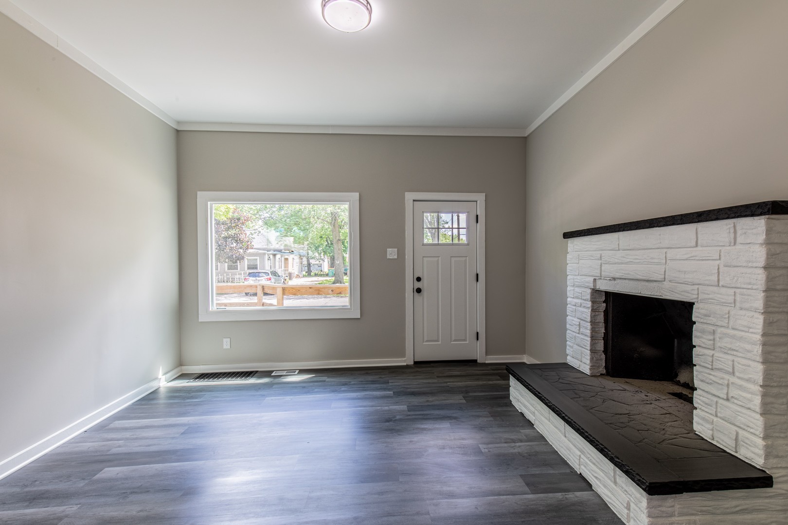 324 Sumner Street Streator, IL 61364 - Photo 12 of 18 an empty room with wooden floor fireplace and windows