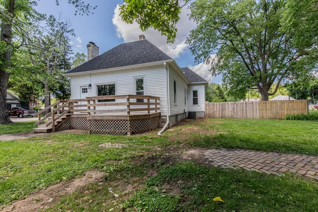 a view of a house with backyard and sitting area