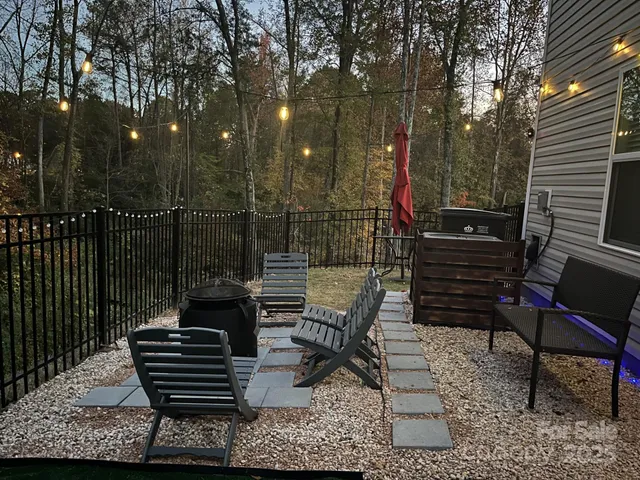 a view of a chairs and bench in the roof deck