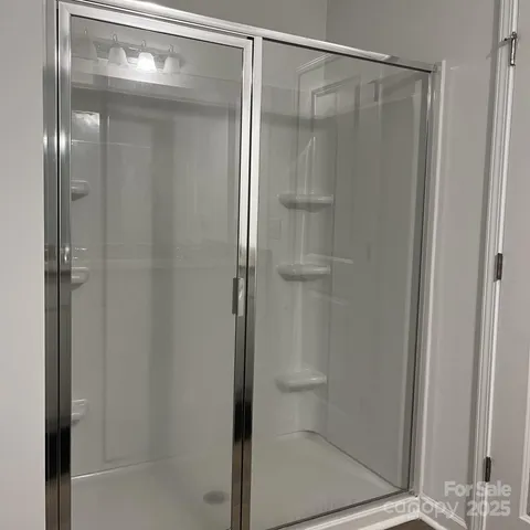 a bathroom with a glass shower door