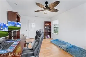 a view of a livingroom with furniture and a ceiling fan