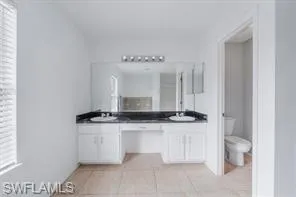 a large bathroom with a granite countertop sink and a mirror