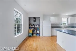 a view of a kitchen with fridge and a sink