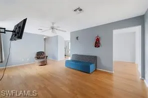 a view of a livingroom with furniture and a ceiling fan