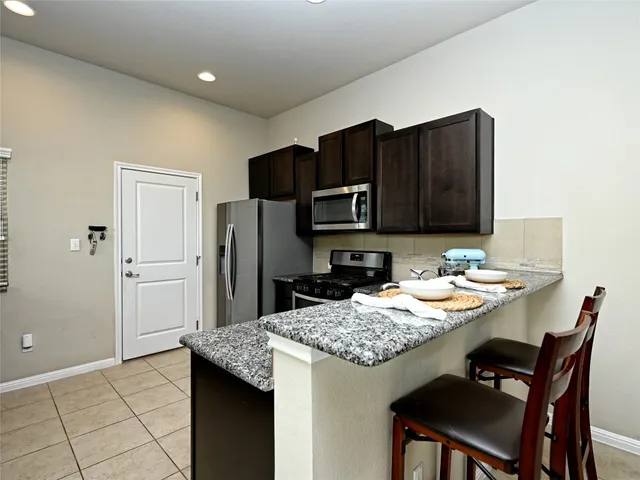 a living room with furniture and kitchen view