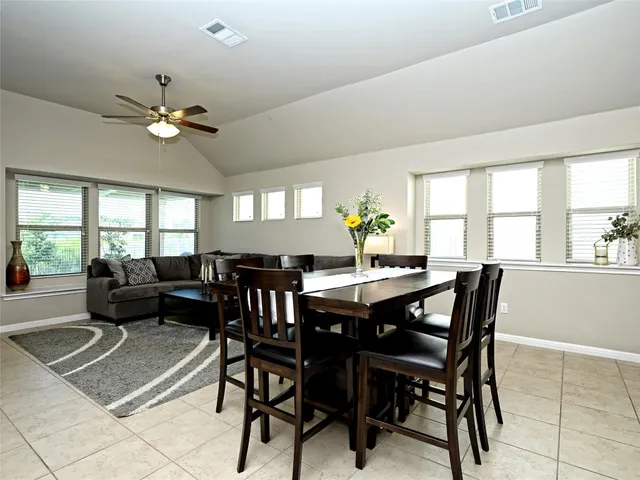 a kitchen with a sink refrigerator and cabinets