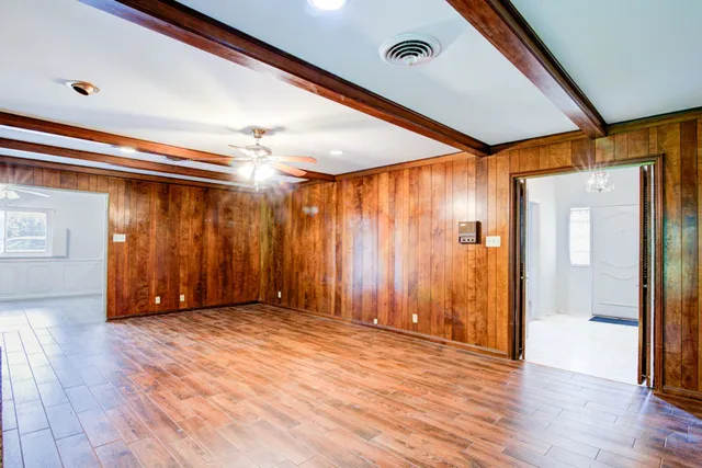 an empty room with closet and a chandelier fan