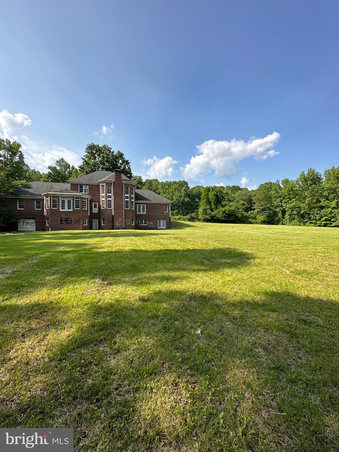 12907 Fletchertown Road Bowie, MD 20720 - Photo 3 of 3 a view of a building with a big yard