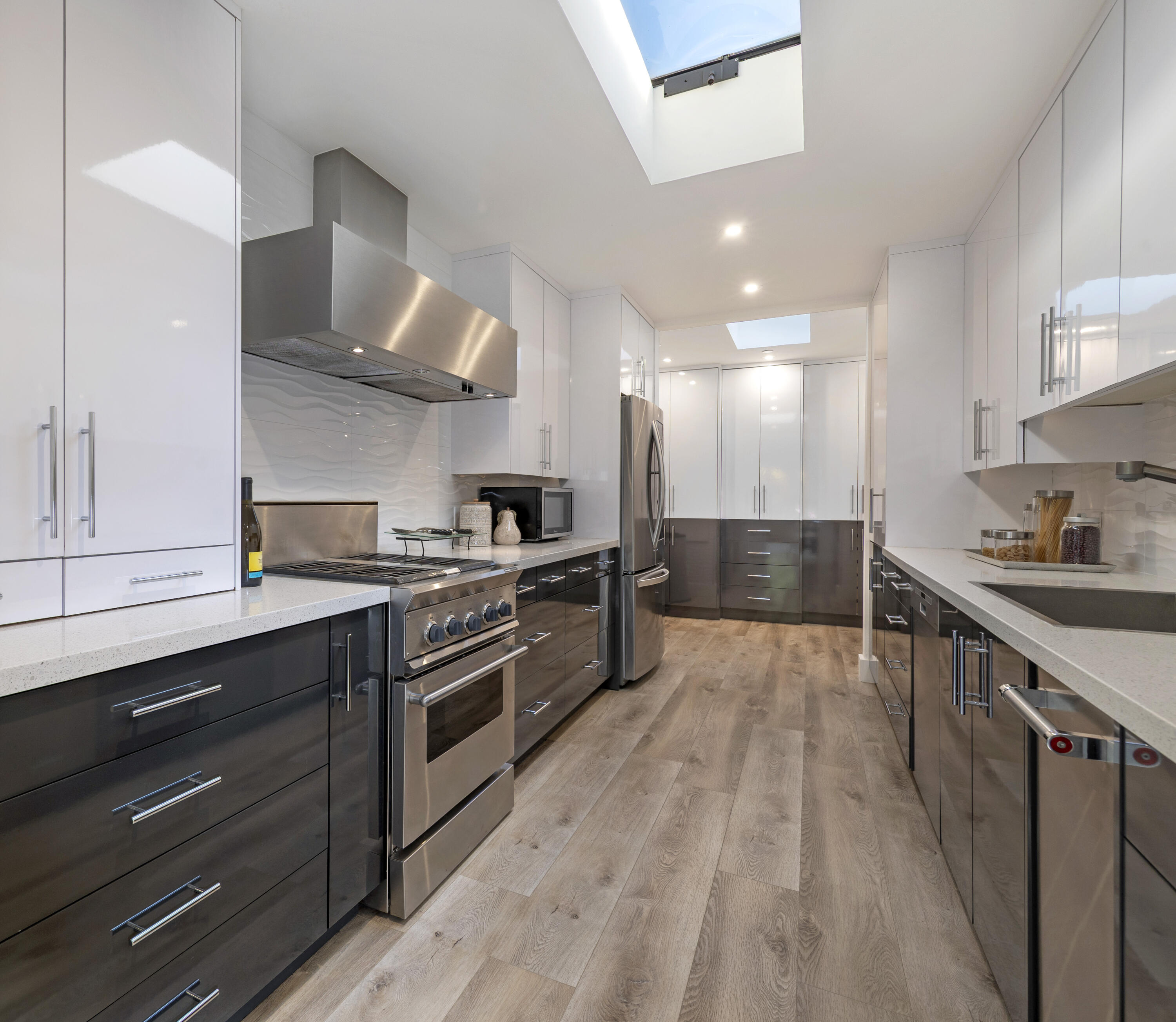 1524 East Valley Road Montecito, CA 93108 - Photo 7 of 19 a large kitchen with stainless steel appliances granite countertop a lot of counter space and wooden floors
