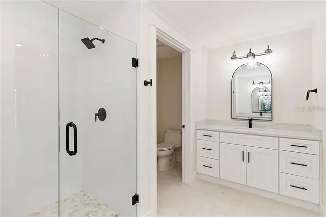 a bathroom with a double vanity sink and mirror with shower