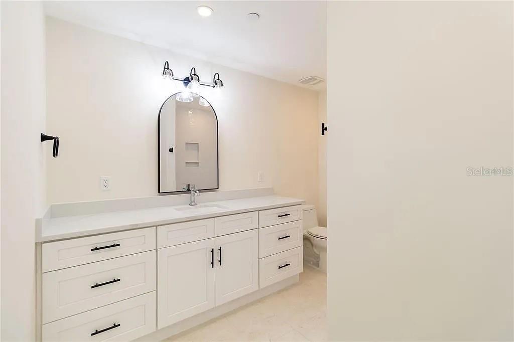 Undisclosed Address Osprey, FL 34229 - Photo 20 of 39 a bathroom with a sink and a mirror