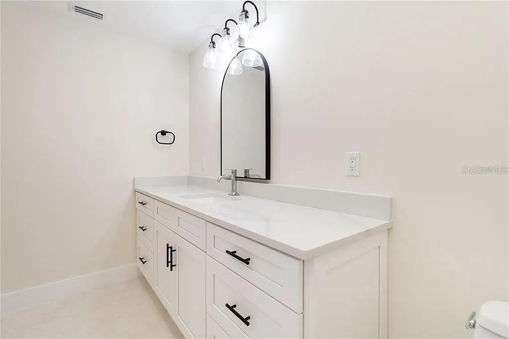 Undisclosed Address Osprey, FL 34229 - Photo 21 of 39 a bathroom with a sink and a mirror
