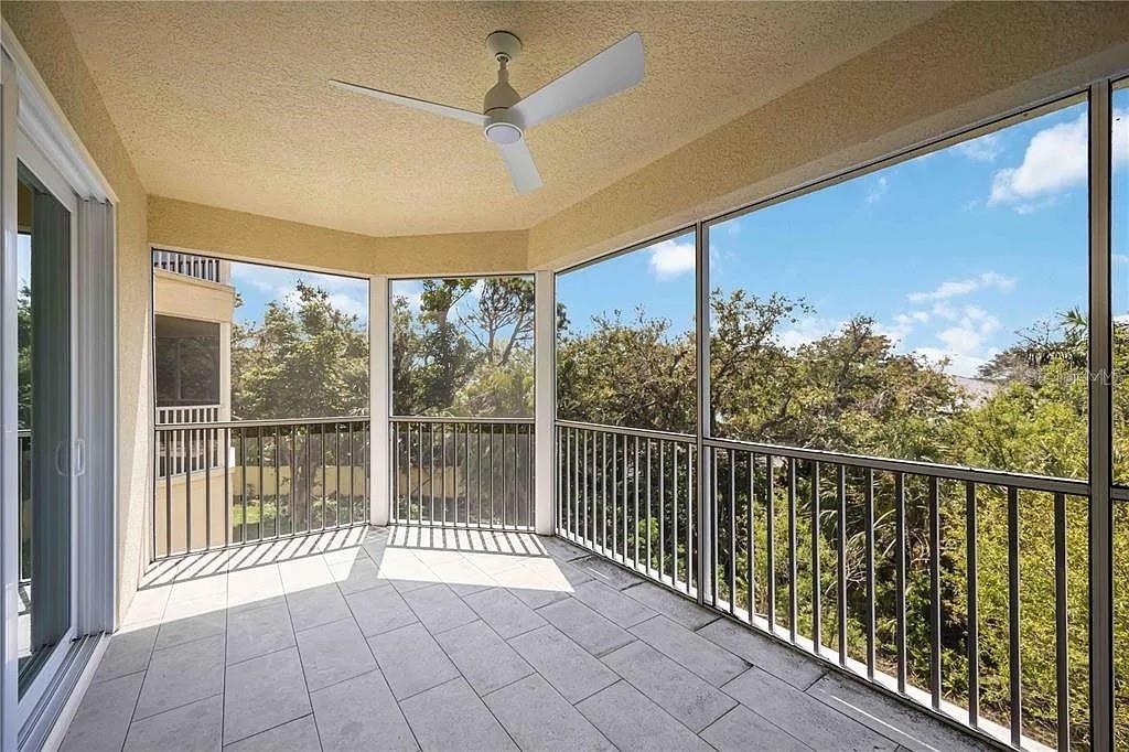 Undisclosed Address Osprey, FL 34229 - Photo 30 of 39 a view of a balcony with lake view and a floor to ceiling window