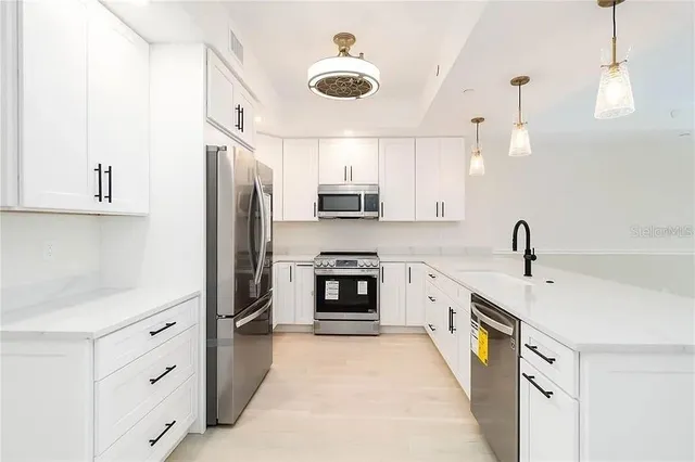 a kitchen with stainless steel appliances granite countertop a stove and a refrigerator