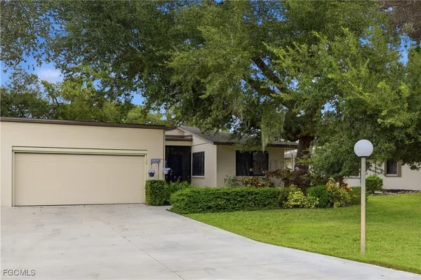 a front view of house with yard and green space