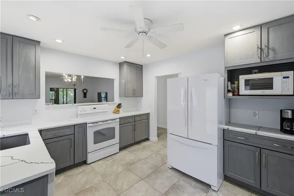 a kitchen with a stove a sink and a refrigerator