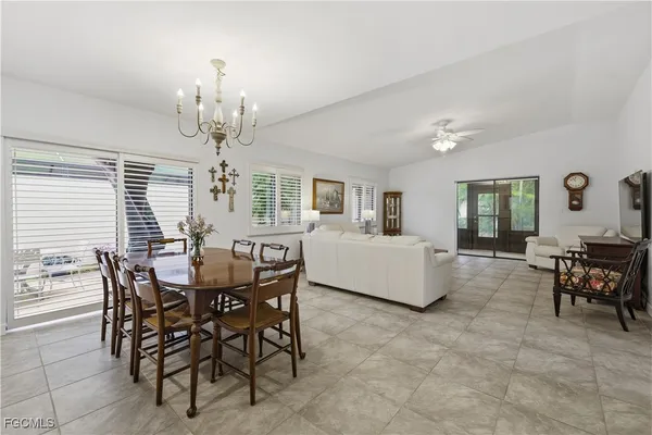 a view of a dining room with furniture and chandelier