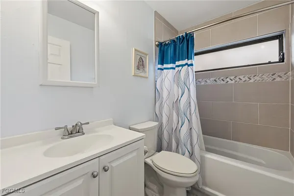a kitchen with a sink and white cabinets