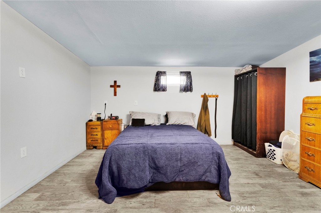 25333 Valley View Road Apple Valley, CA 92308 - Photo 14 of 37 a bedroom with furniture and a flat tv screen