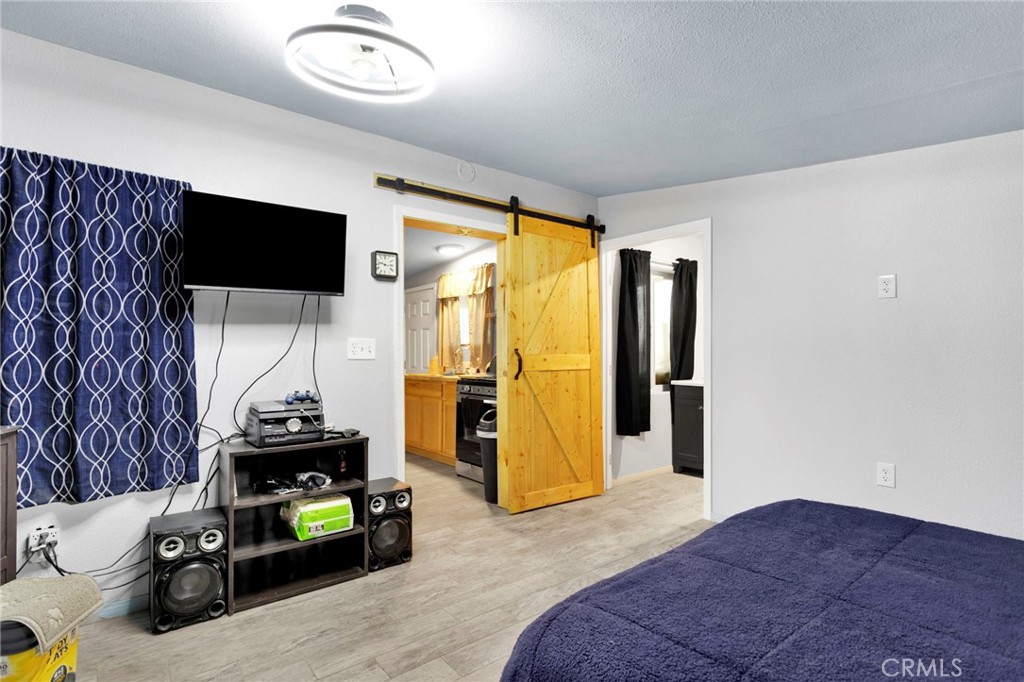 25333 Valley View Road Apple Valley, CA 92308 - Photo 16 of 37 a bedroom with a bed and a flat screen tv