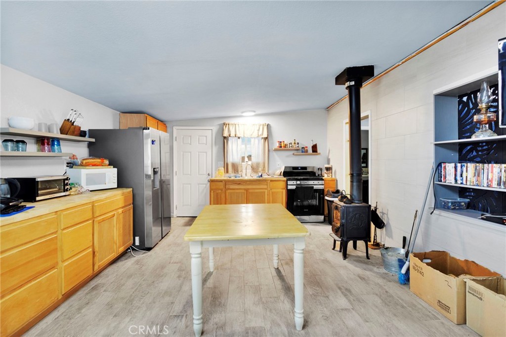 25333 Valley View Road Apple Valley, CA 92308 - Photo 7 of 37 a large living room with stainless steel appliances furniture a rug and a book shelf