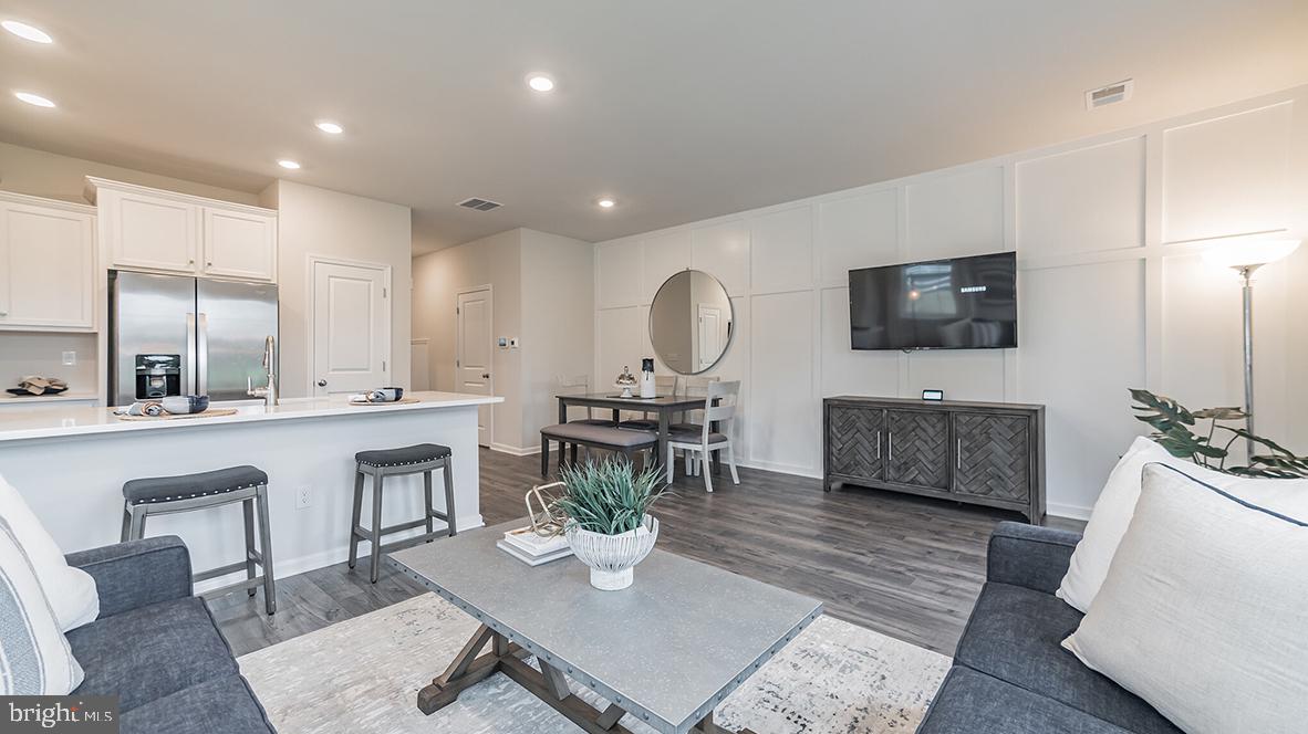 87 Alexander Way Westampton, NJ 08060 - Photo 4 of 23 a living room with furniture a flat screen tv and kitchen view