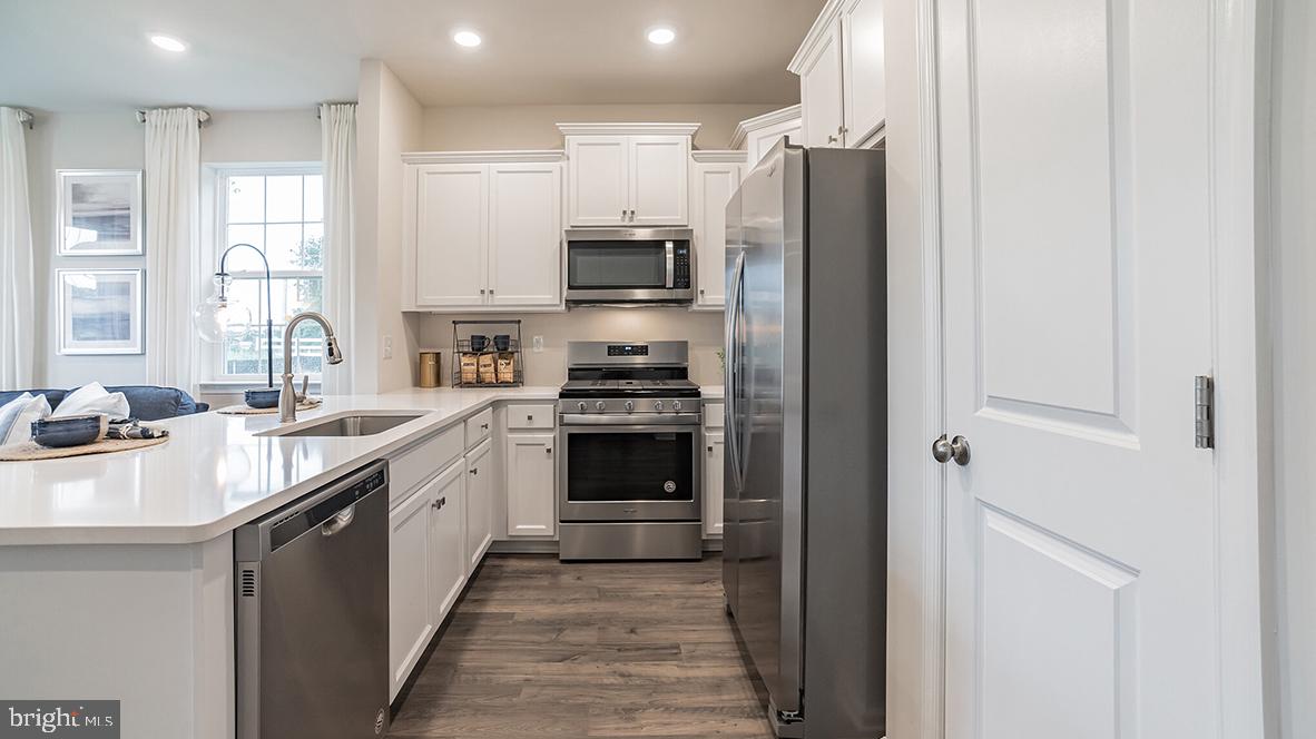 87 Alexander Way Westampton, NJ 08060 - Photo 9 of 23 a kitchen with stainless steel appliances a refrigerator sink and stove