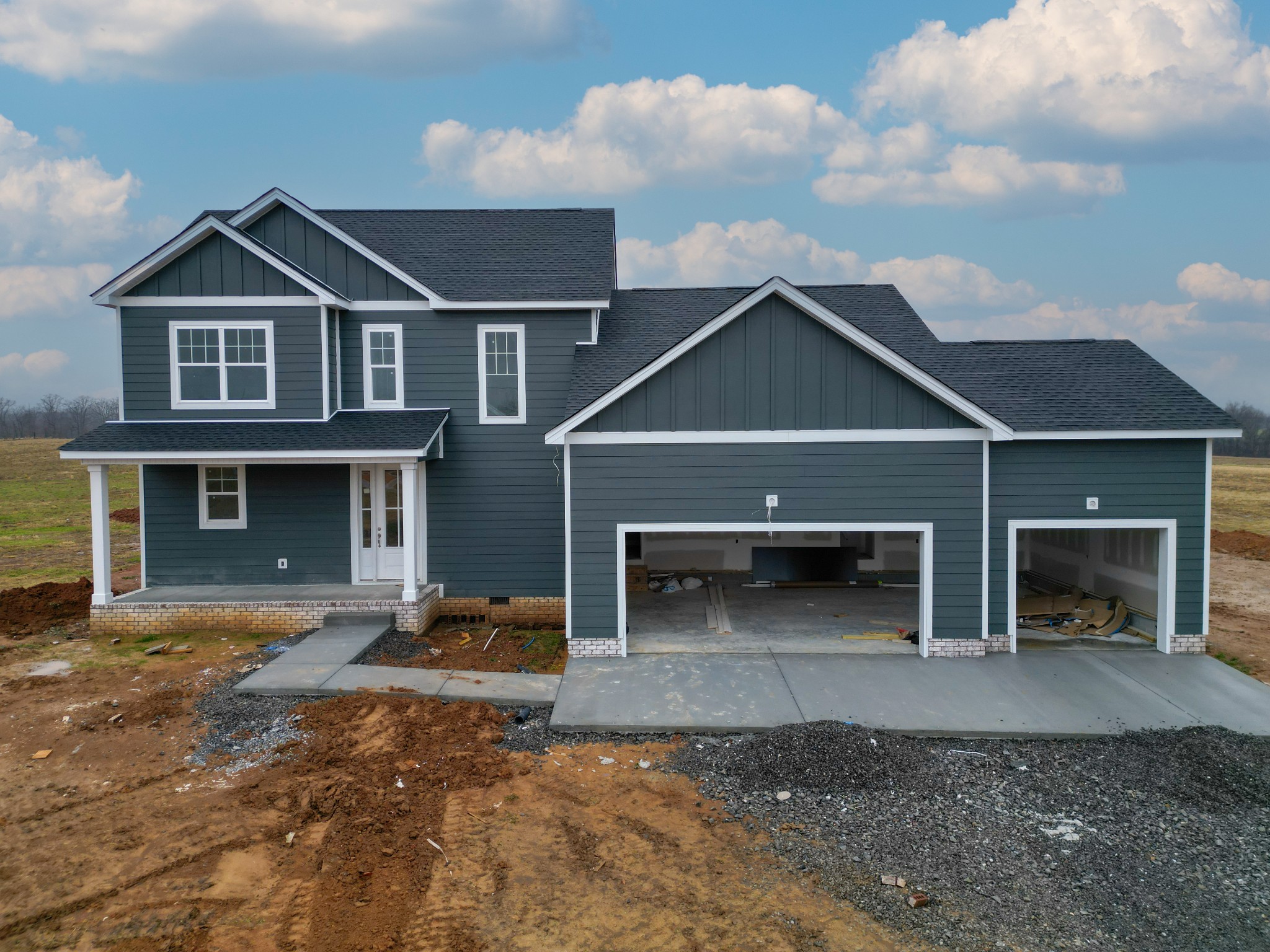 a front view of a house with yard and parking space
