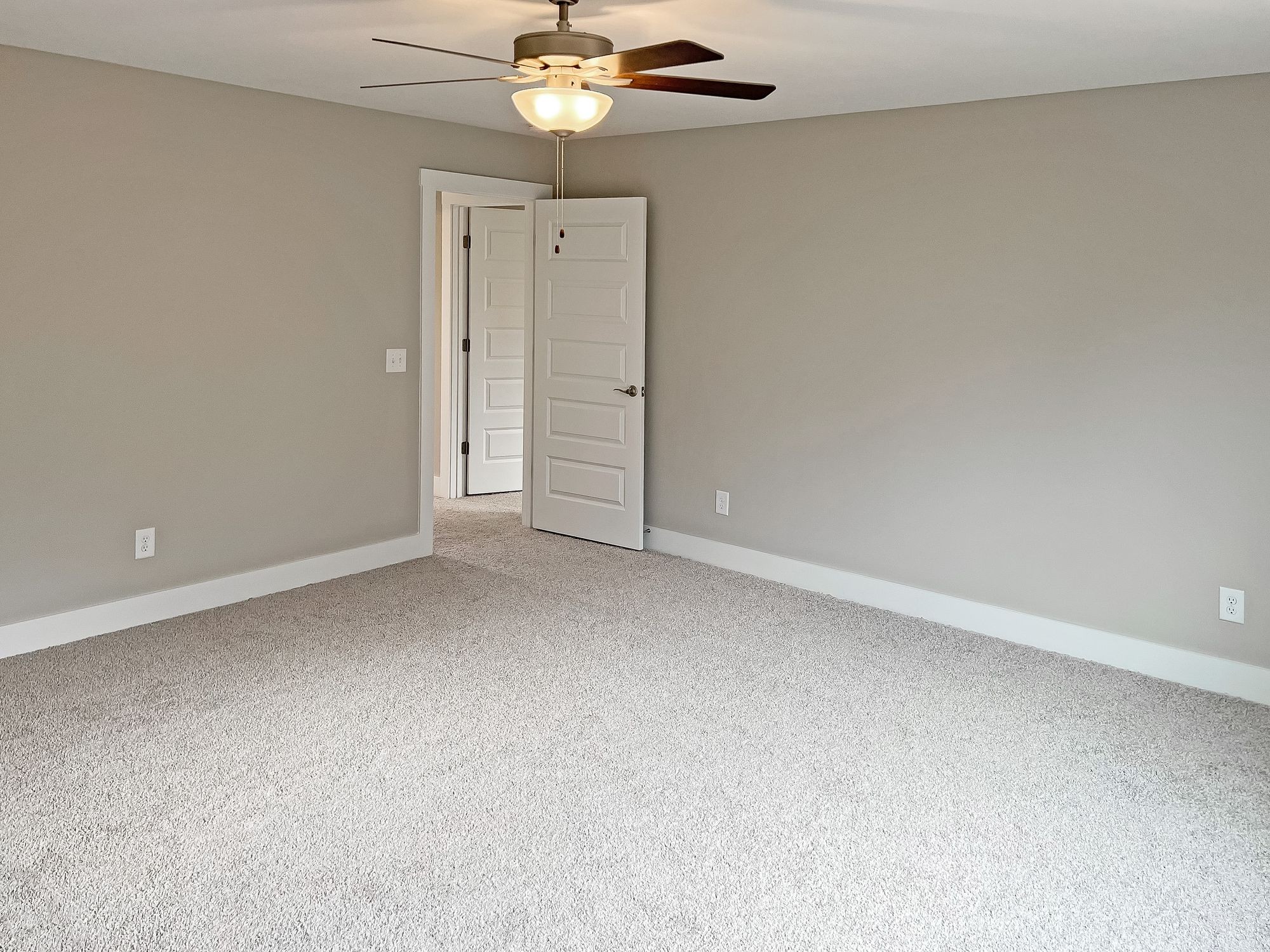 5140 Starks Road Cross Plains, TN 37049 - Photo 16 of 17 an empty room with a chandelier fan and wooden floor