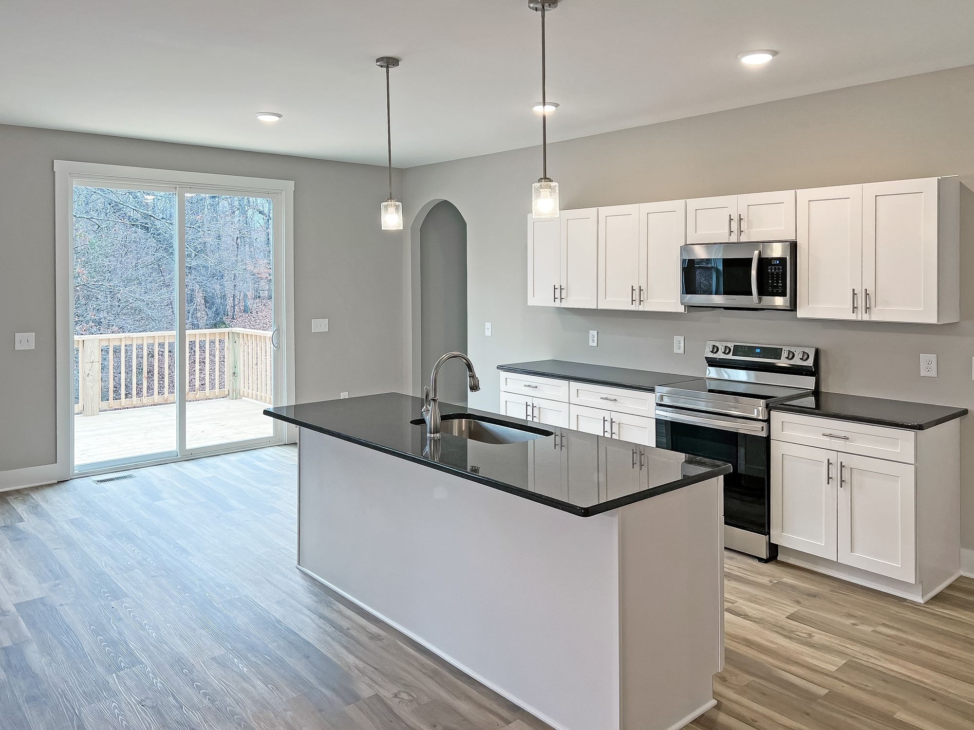 5140 Starks Road Cross Plains, TN 37049 - Photo 6 of 17 a kitchen with stainless steel appliances granite countertop a sink a stove and a wooden floor