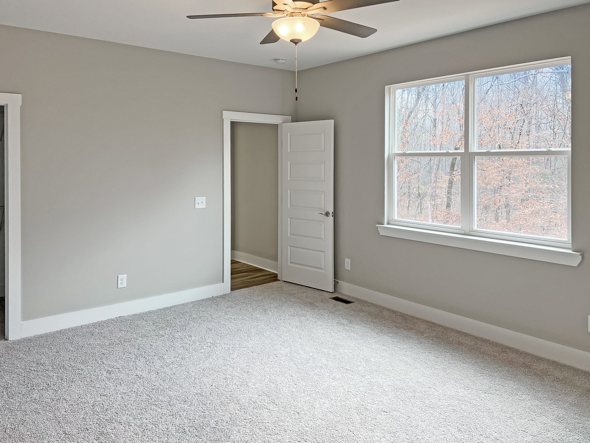 5140 Starks Road Cross Plains, TN 37049 - Photo 9 of 17 an empty room with a chandelier fan and windows
