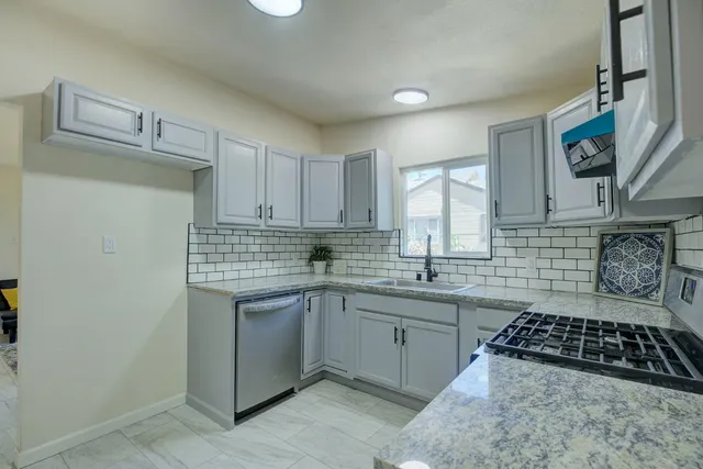 a kitchen with sink and cabinets