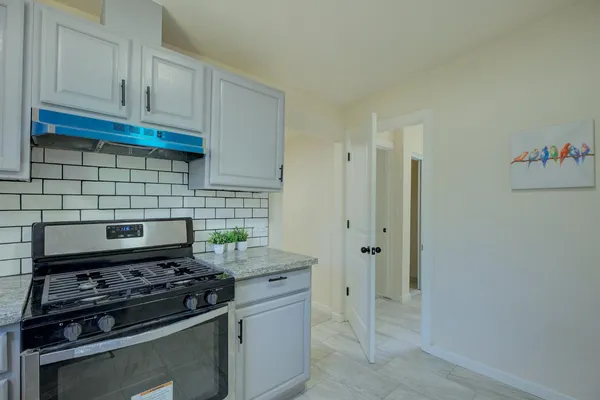 a kitchen with stainless steel appliances a stove and a refrigerator