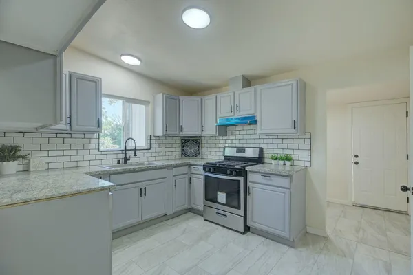 a kitchen with a sink cabinets and stainless steel appliances