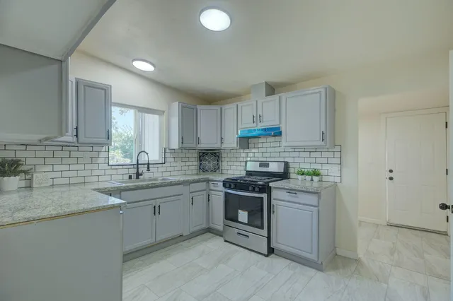 a kitchen with a sink cabinets and stainless steel appliances