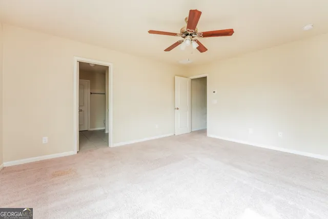 a view of a livingroom with a ceiling fan and a ceiling fan