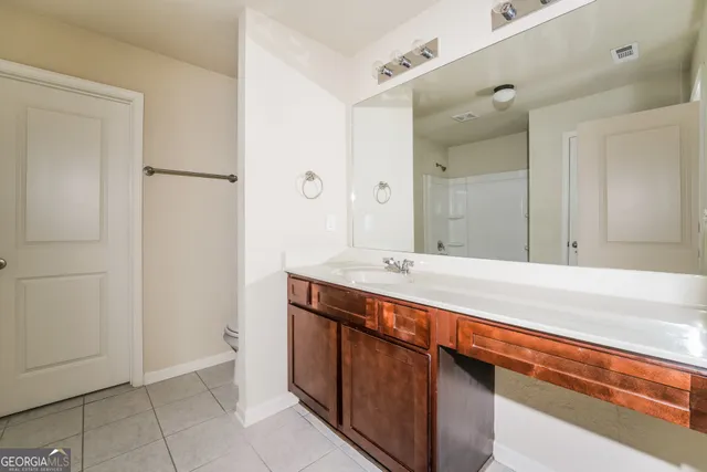a spacious bathroom with a sink and a mirror