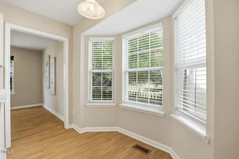 a view of a room with wooden floor and windows