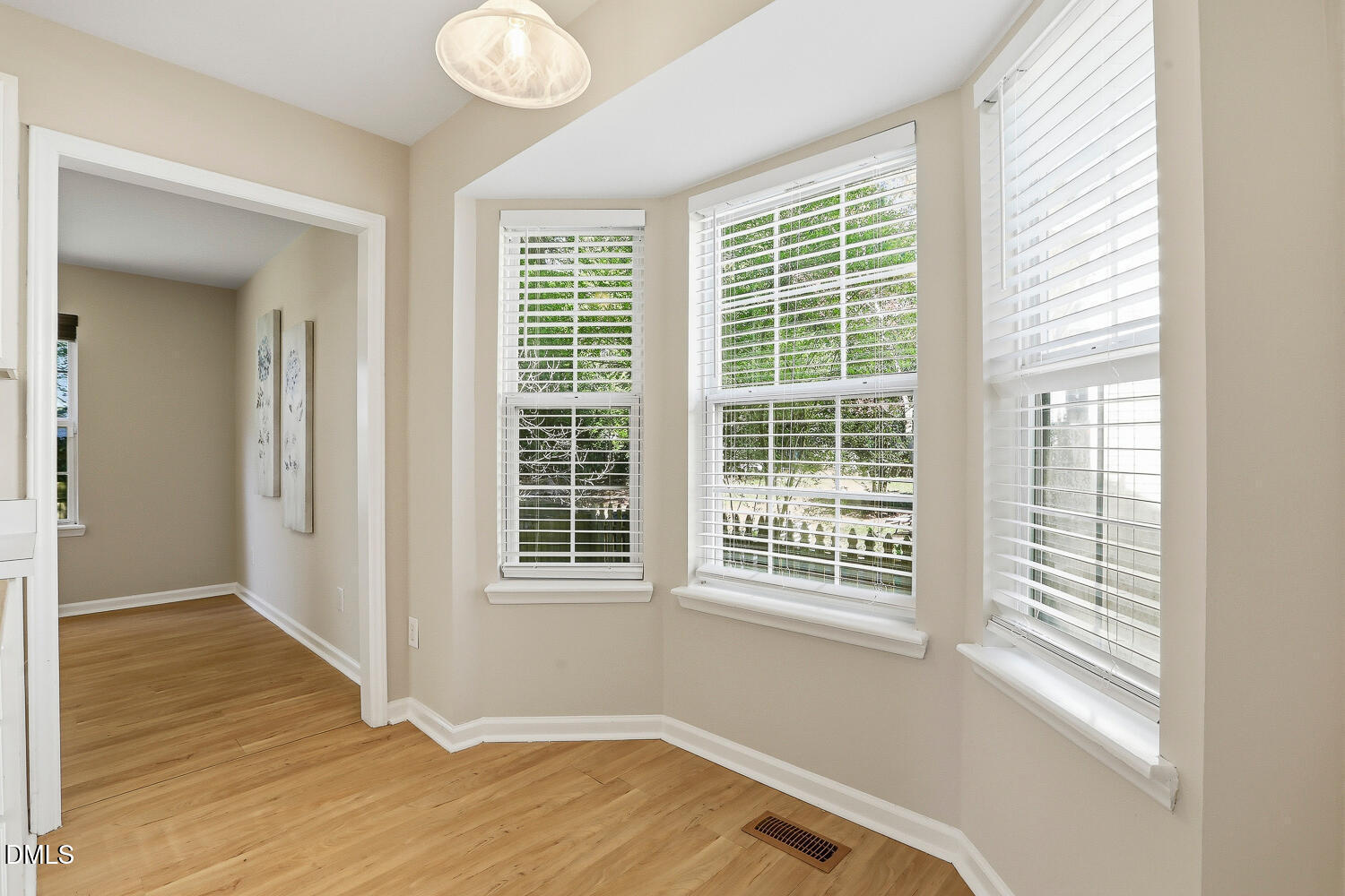1220 Stoneferry Lane Raleigh, NC 27606 - Photo 11 of 40 a view of a room with wooden floor and windows