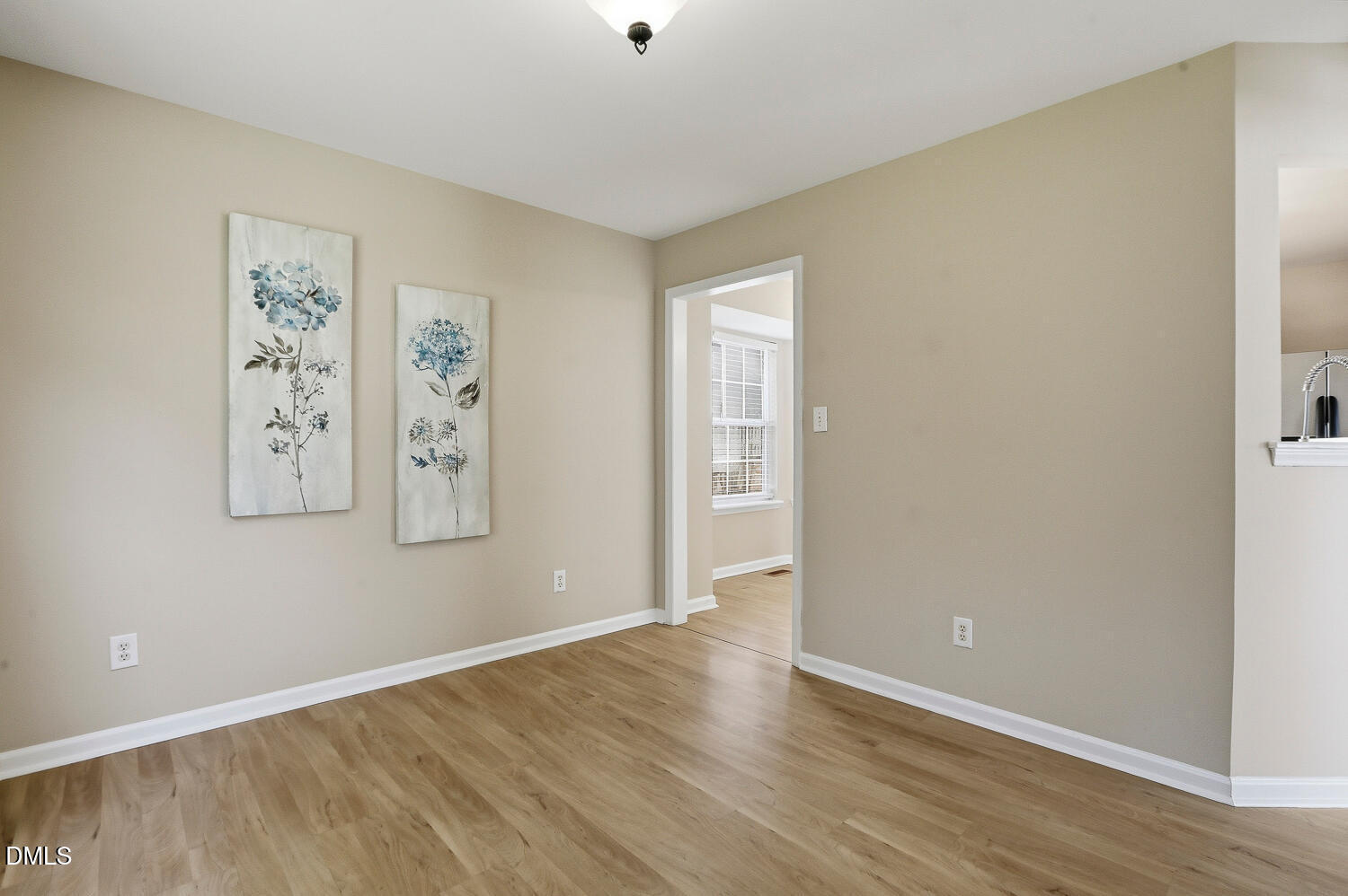 1220 Stoneferry Lane Raleigh, NC 27606 - Photo 12 of 40 an empty room with painting and refrigerator