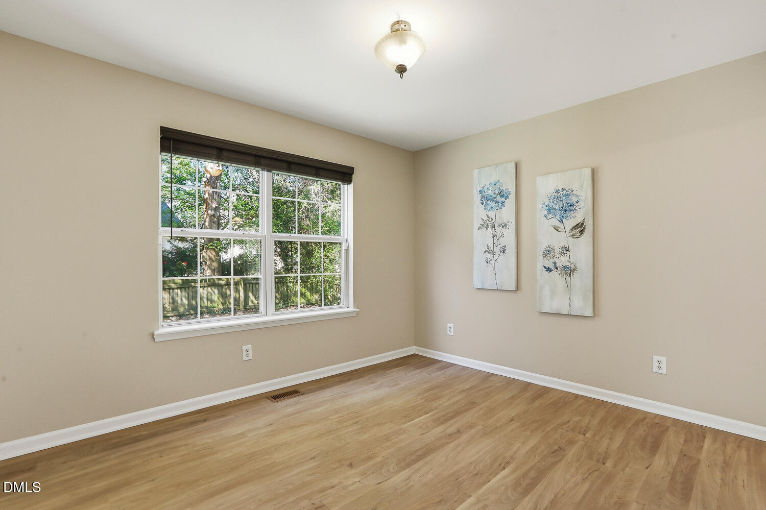 1220 Stoneferry Lane Raleigh, NC 27606 - Photo 13 of 40 a view of an empty room with a window and wooden floor