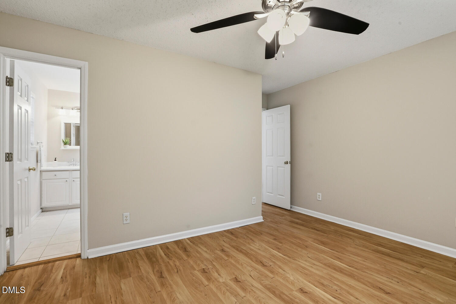 1220 Stoneferry Lane Raleigh, NC 27606 - Photo 17 of 40 an empty room with a ceiling fan and wooden floor